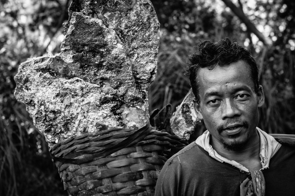 The volcano man..@squibble and I met this man at about 7AM . He said he woke up at  about 3AM, hiked into the volcano in the dark, loaded his basket with about 90kg (200lb) of sulfur. He then carried it back up the trecherous slope of the volcano, 2km almost straight up and hiked down another 4km to sell the goods for about US $5. The main use of the sulfur is to whiten sugar..He said, if he is lucky, he'll do this one more time before 2PM because by then, the heat and sulfuric acid fumes in the volcano get unbearable. Did I mention, he was not wearing shoes let alone a respirator? . These miners have no other means to make a living in that remote part of Java. Apparently, lung disease is the leading cause of death among men there;  average lifespan - 45yrs. @squibble and I were distributing "glucose buiscuts" (sugar cookies) to these guys as they went about thier work. A poor compensation for helping us whiten our sugar. Don't you think?